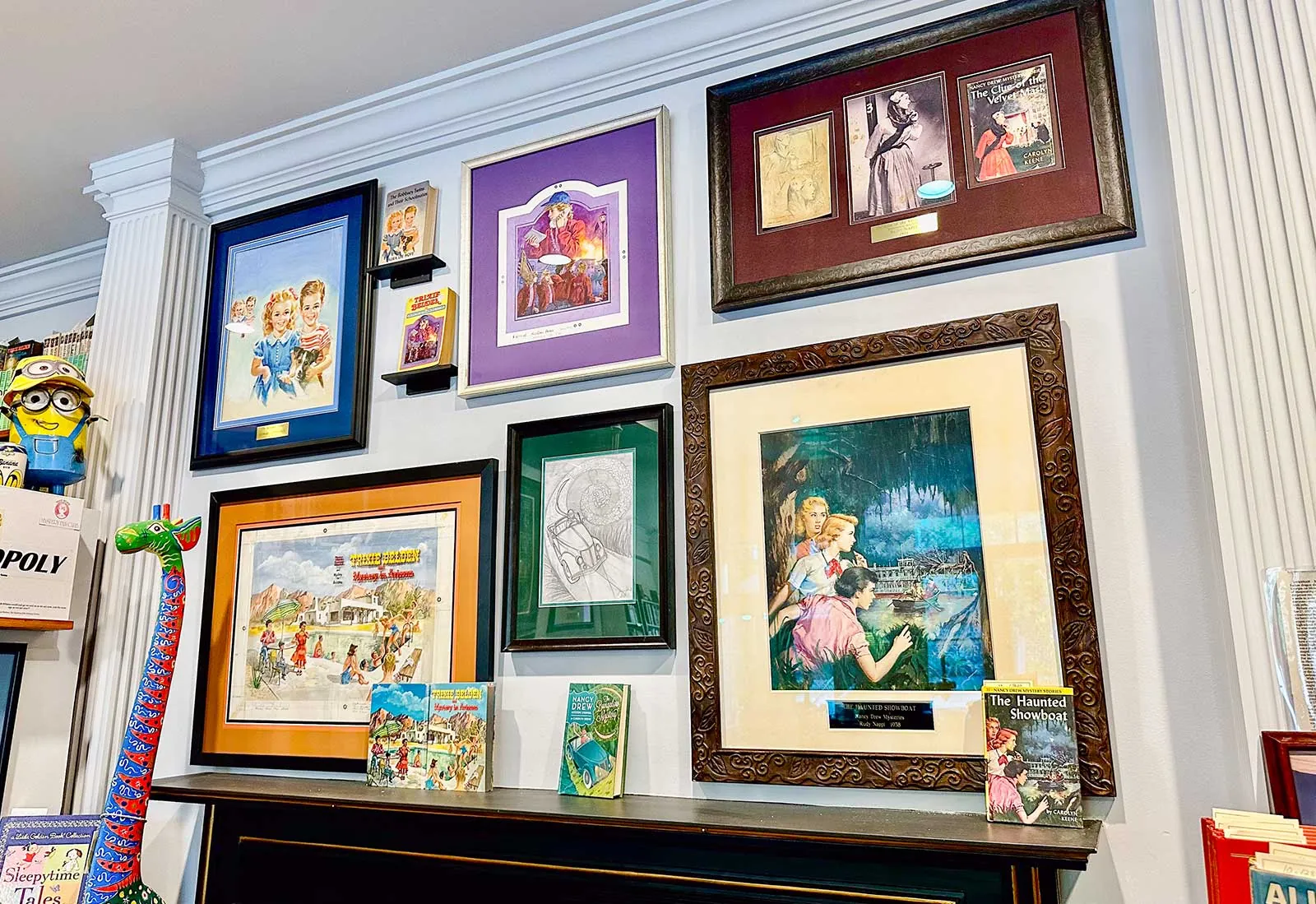 Series book cover art at Books on Bay, Savannah Framed original cover art from vintage series books on the wall at Books on Bay in Savannah, GA